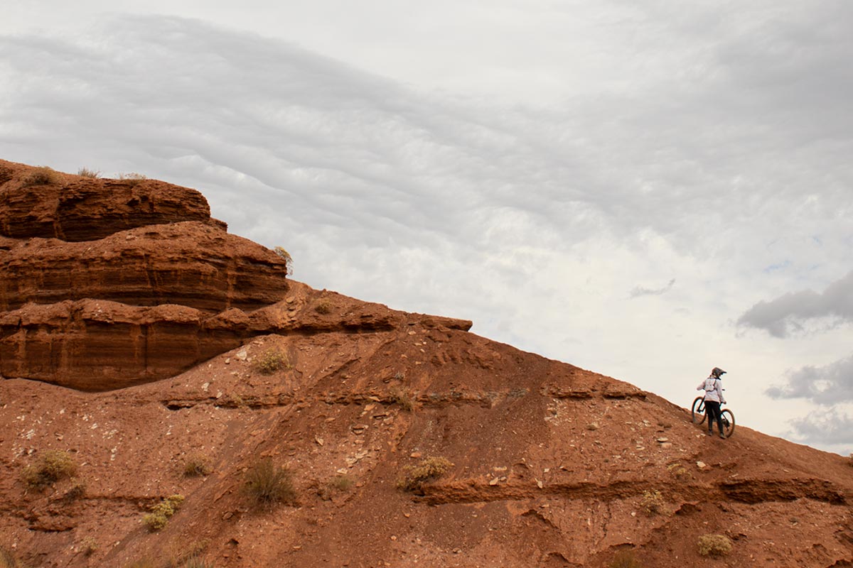 Wyatt hikes his mountain bike up a ridge