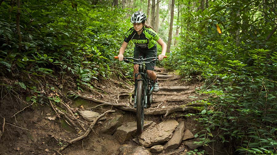 Hannah mountain biking in the woods