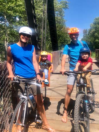 Young family mountain biking with kids