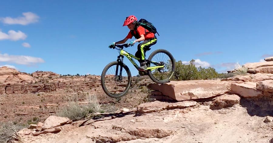 Tyge sends a drop while riding The Whole Enchilada in Moab