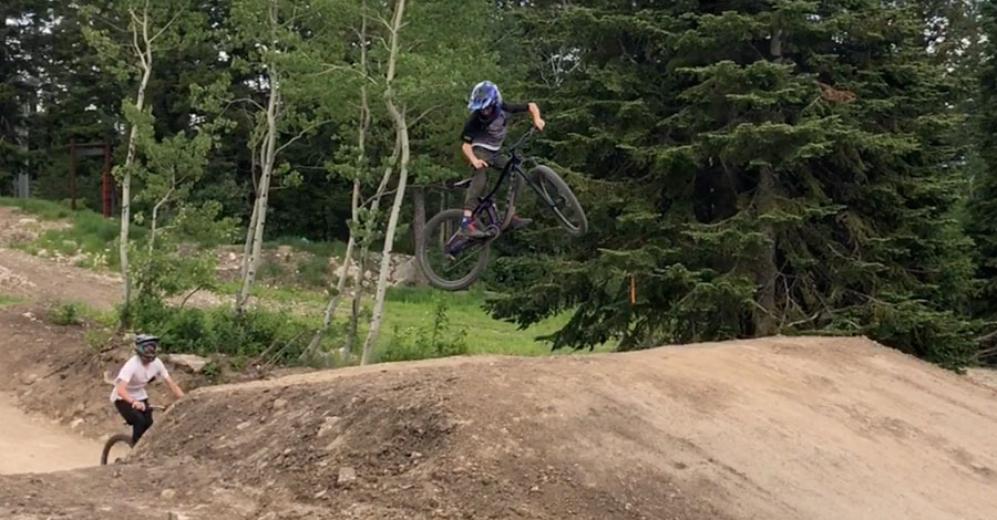 Hitting a table jump at the Jackson Hole mountain bike park