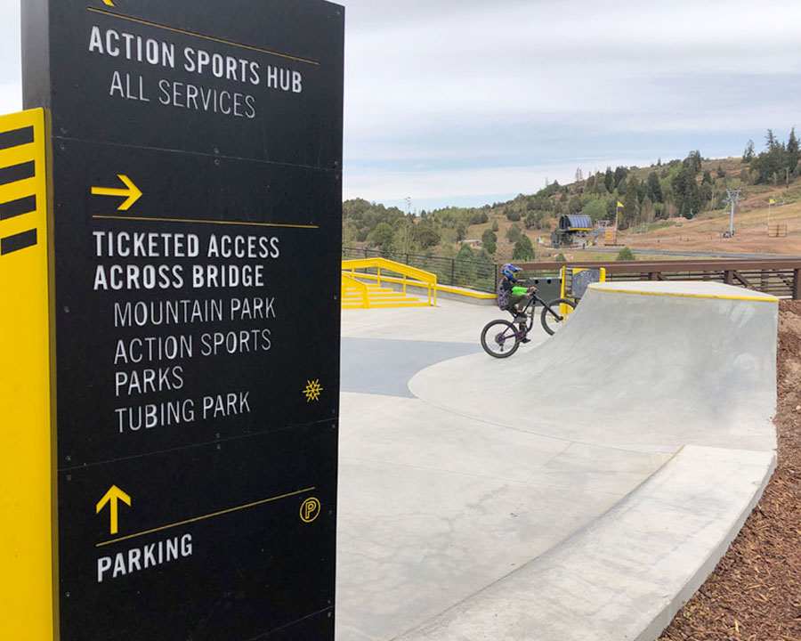 Outdoor plaza signage at Woodward Park City