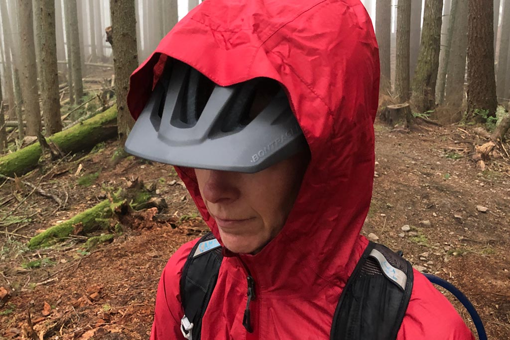 Hood over mtb helmet on the Bontrager Avert Women's Rain Jacket